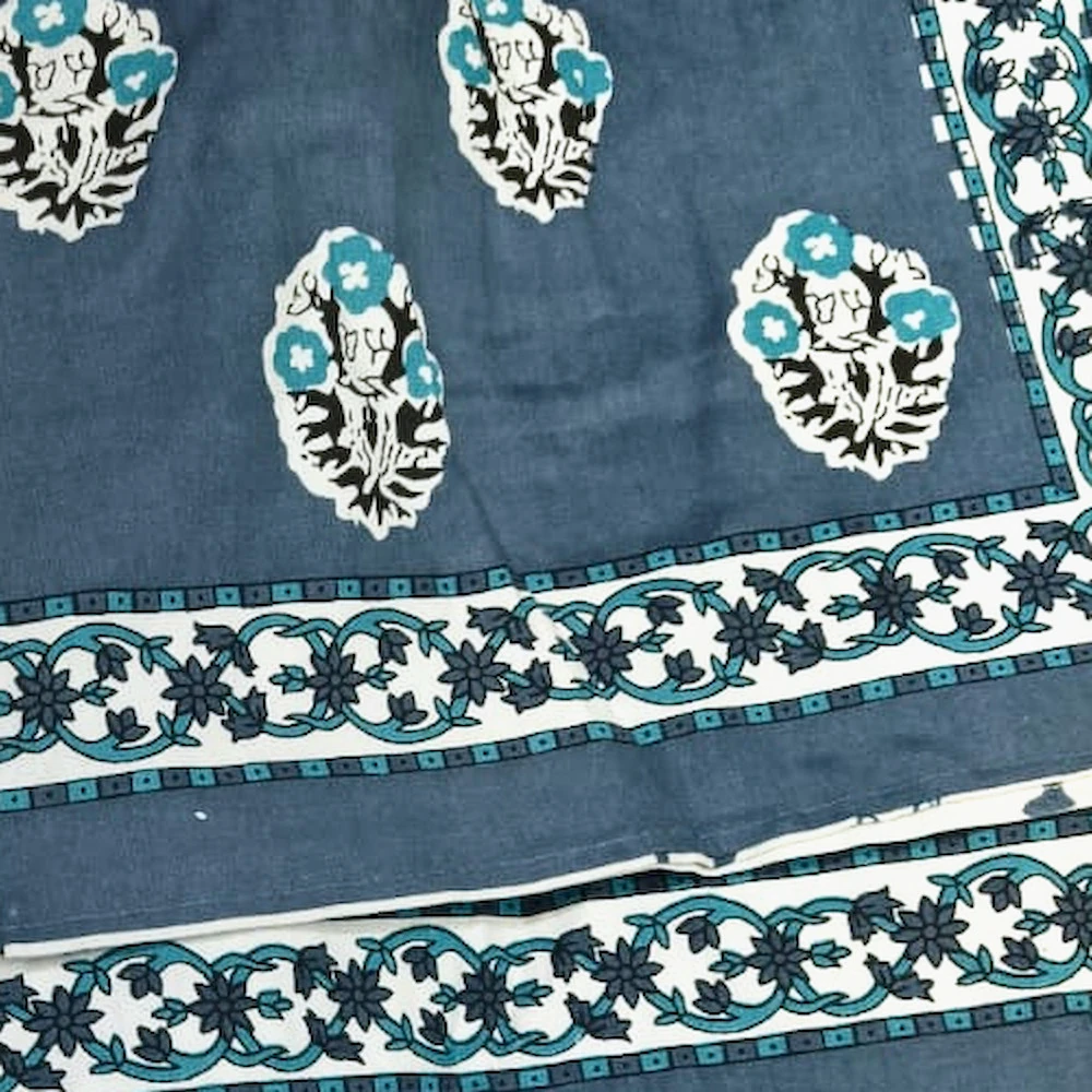 Close-up of The Camels: camels in cream roundels on blush pink, with blue paisley pillowcases.