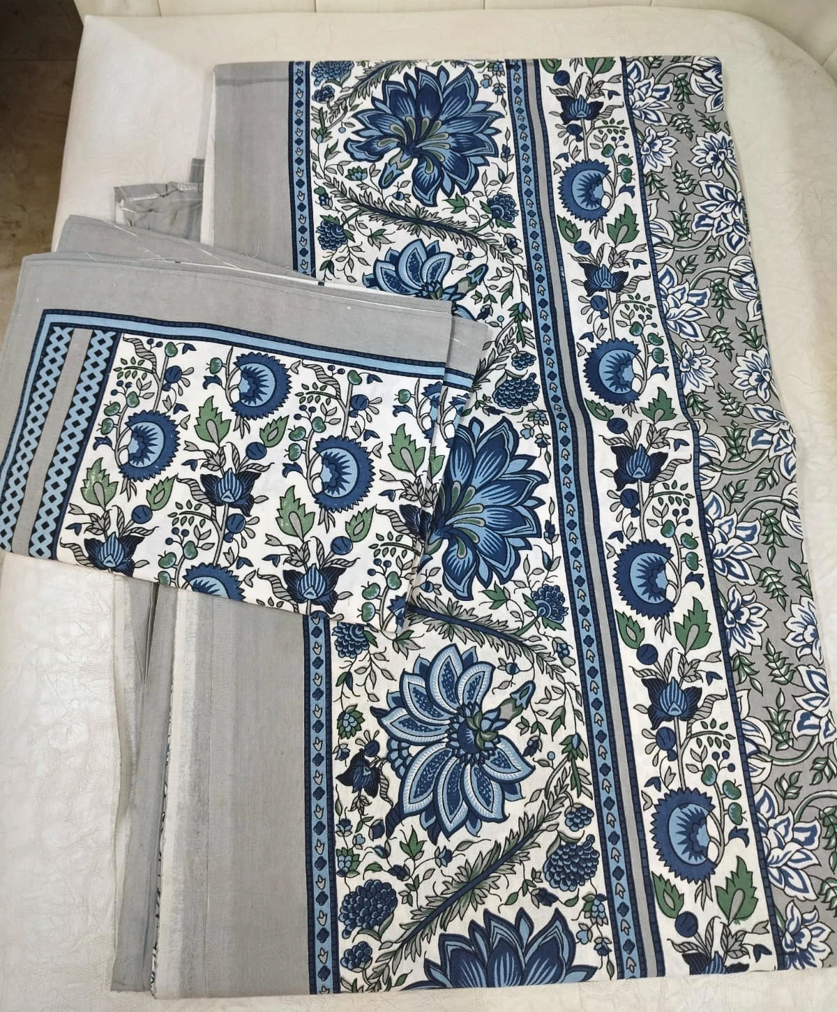The Cornflower: dense indigo and blue flowers on white with a striped blue border, folded.