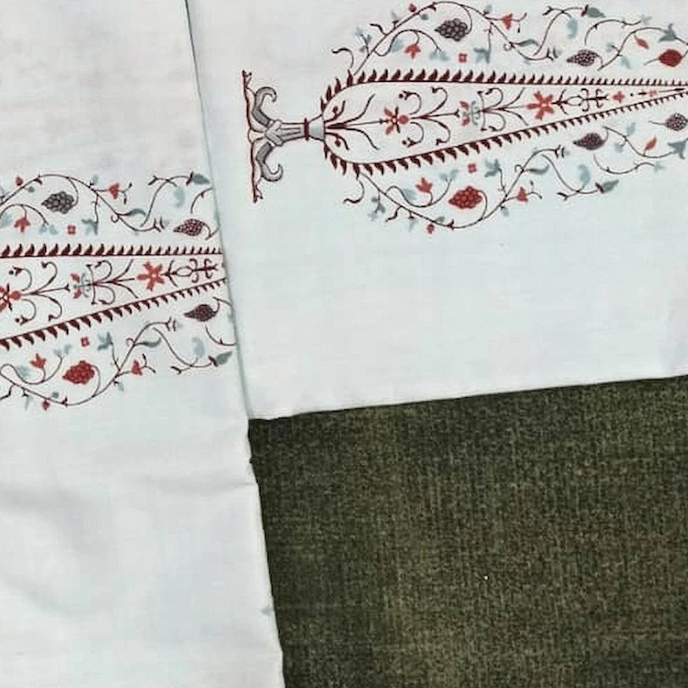 Close-up of The Cypress: tall red tree motifs on white and cream.