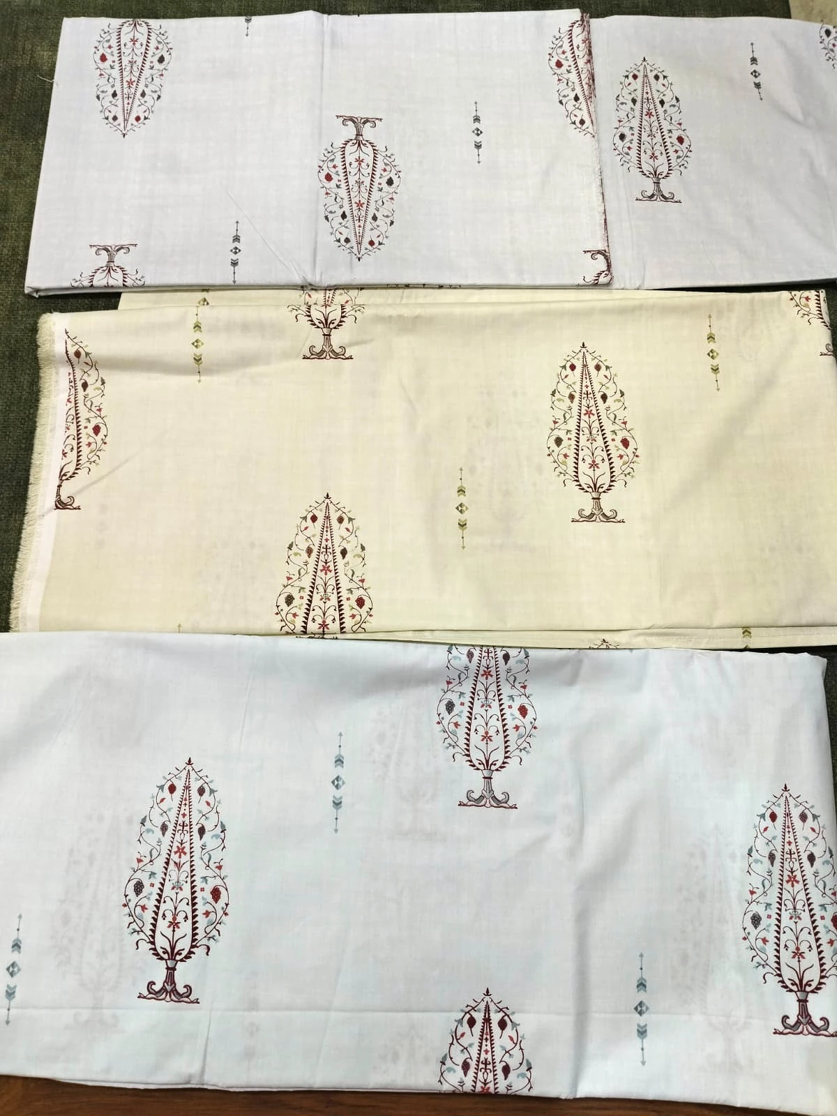 The Cypress: tall red tree motifs on white and cream, folded.