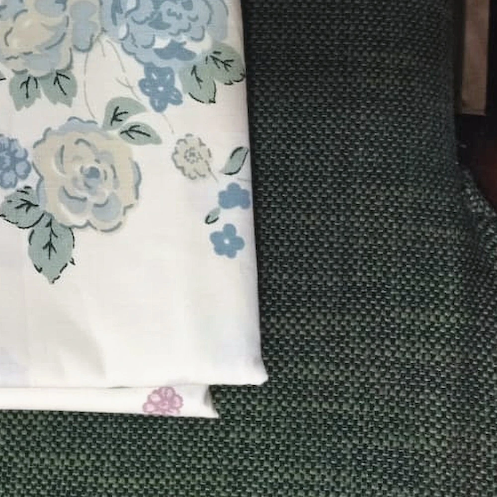 Close-up of The Posy: soft sprays of blue and pink flowers on white.