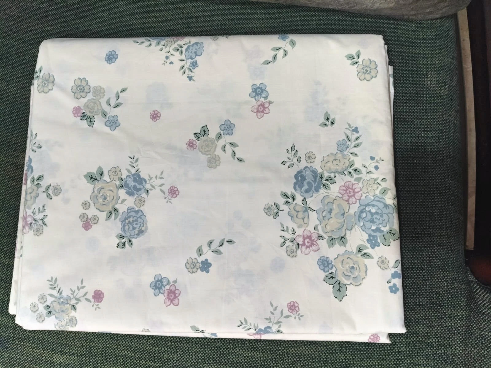 The Posy: soft sprays of blue and pink flowers on white, folded.