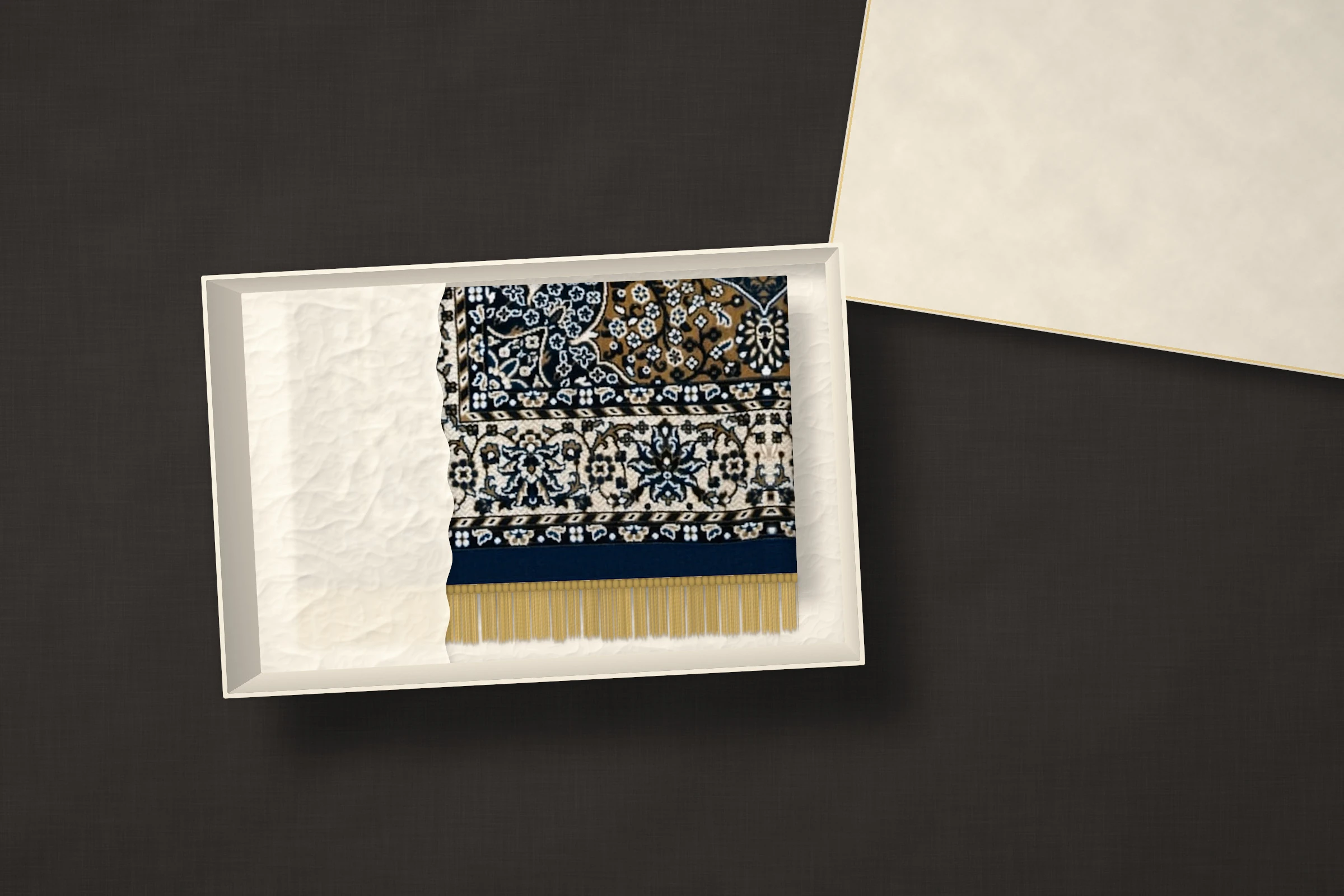 The Saffron Medallion: ochre field with a navy scalloped medallion, a cream border of blue flowers and a navy edge, folded in ivory tissue inside a gift box.