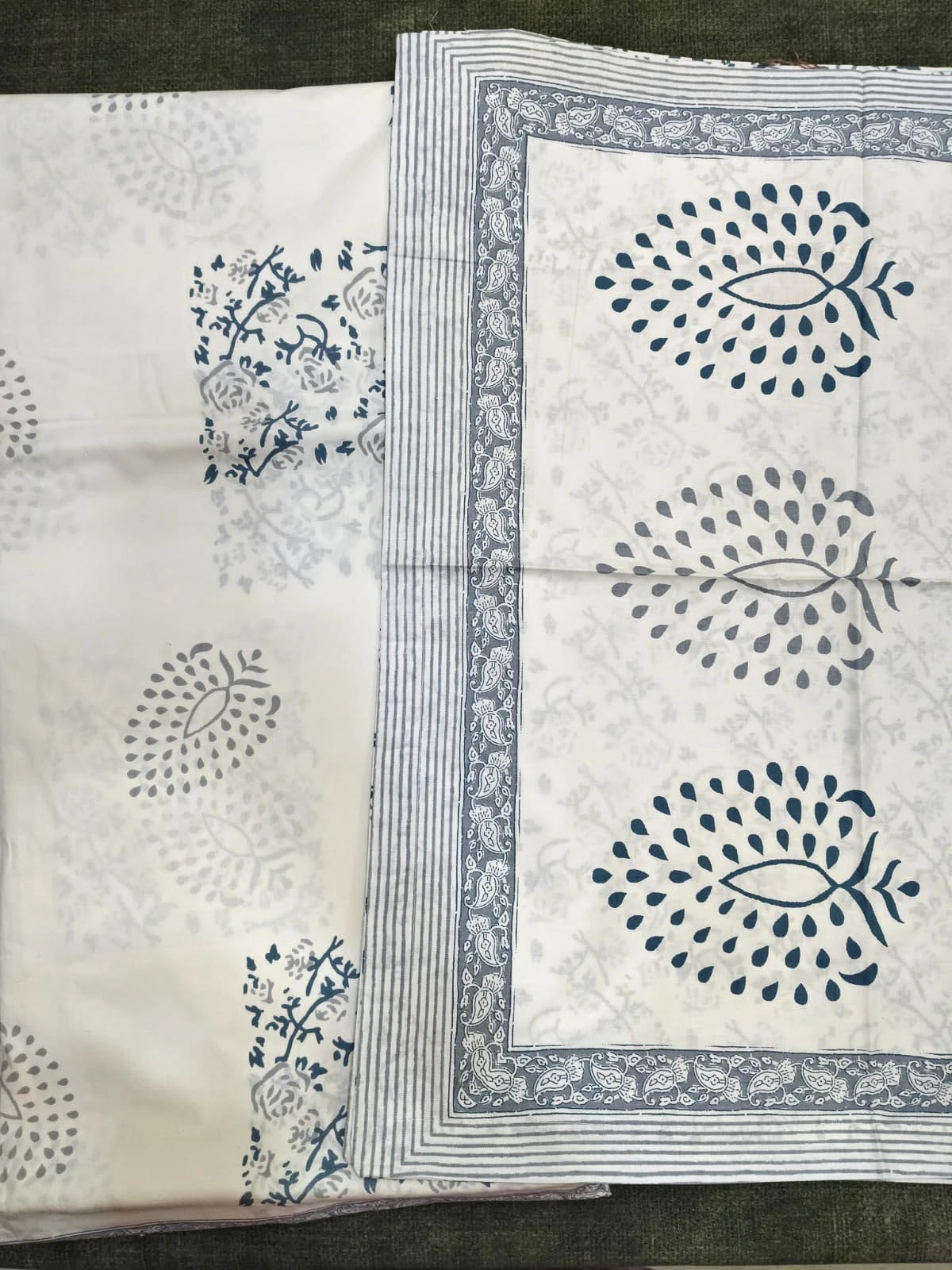The Silverleaf: large grey leaf motifs on white with a patterned grey border, folded.
